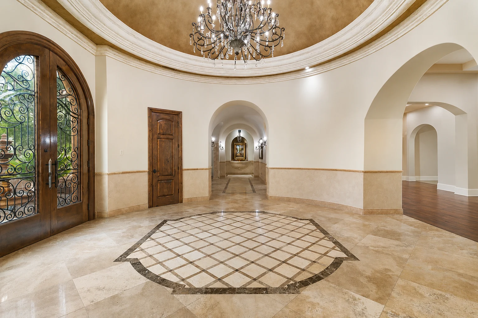 Grand entry rotunda with chandelier and stone floors