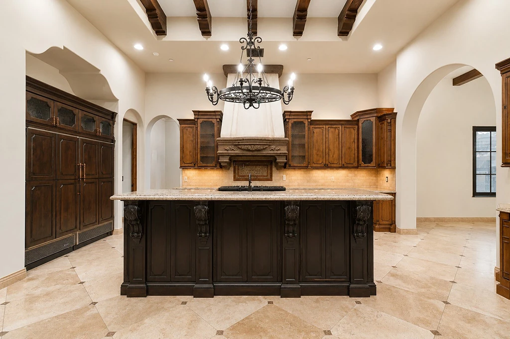 Chef kitchen island with custom cabinetry and chandelier