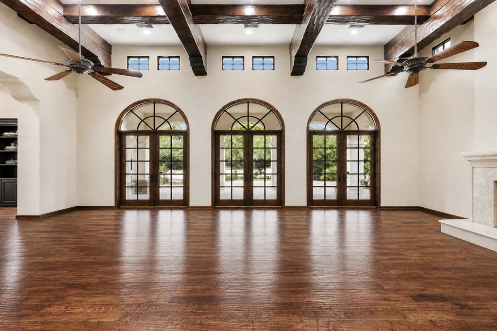 Unfurnished great room with arched glass doors and wood floors