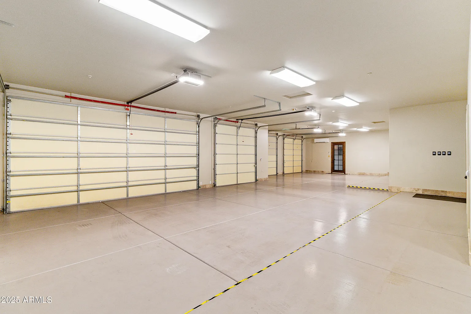 Five-car air-conditioned garage bays with polished floors and overhead doors